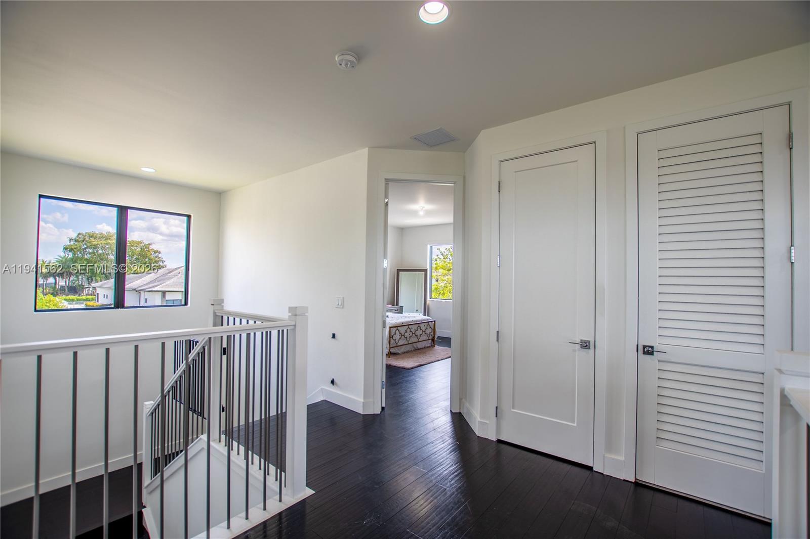 15821 Southwest 49th Street Southwest Ranches, FL 33331 - Photo 23 of 67 a view of a hallway with wooden floor and windows