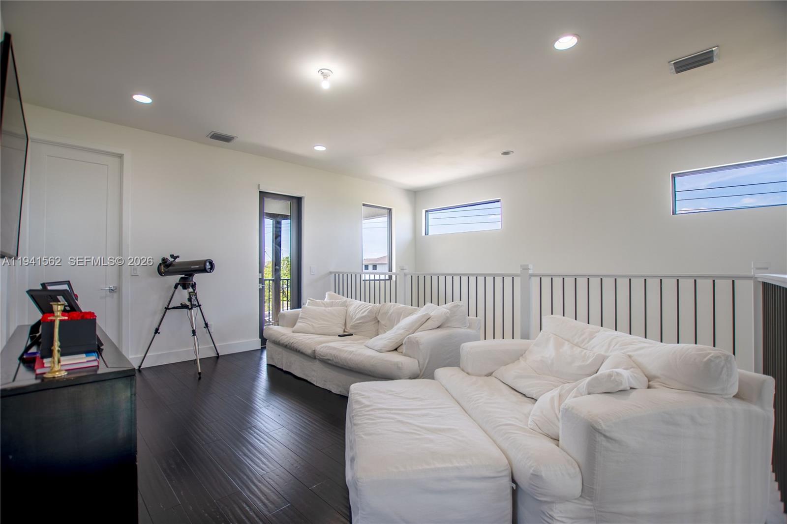 15821 Southwest 49th Street Southwest Ranches, FL 33331 - Photo 24 of 67 a living room with furniture a wooden floor and a chandelier