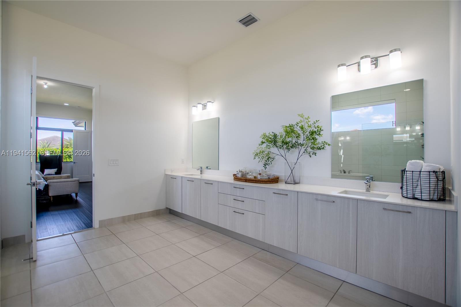 15821 Southwest 49th Street Southwest Ranches, FL 33331 - Photo 29 of 67 a bathroom with a sink and a mirror
