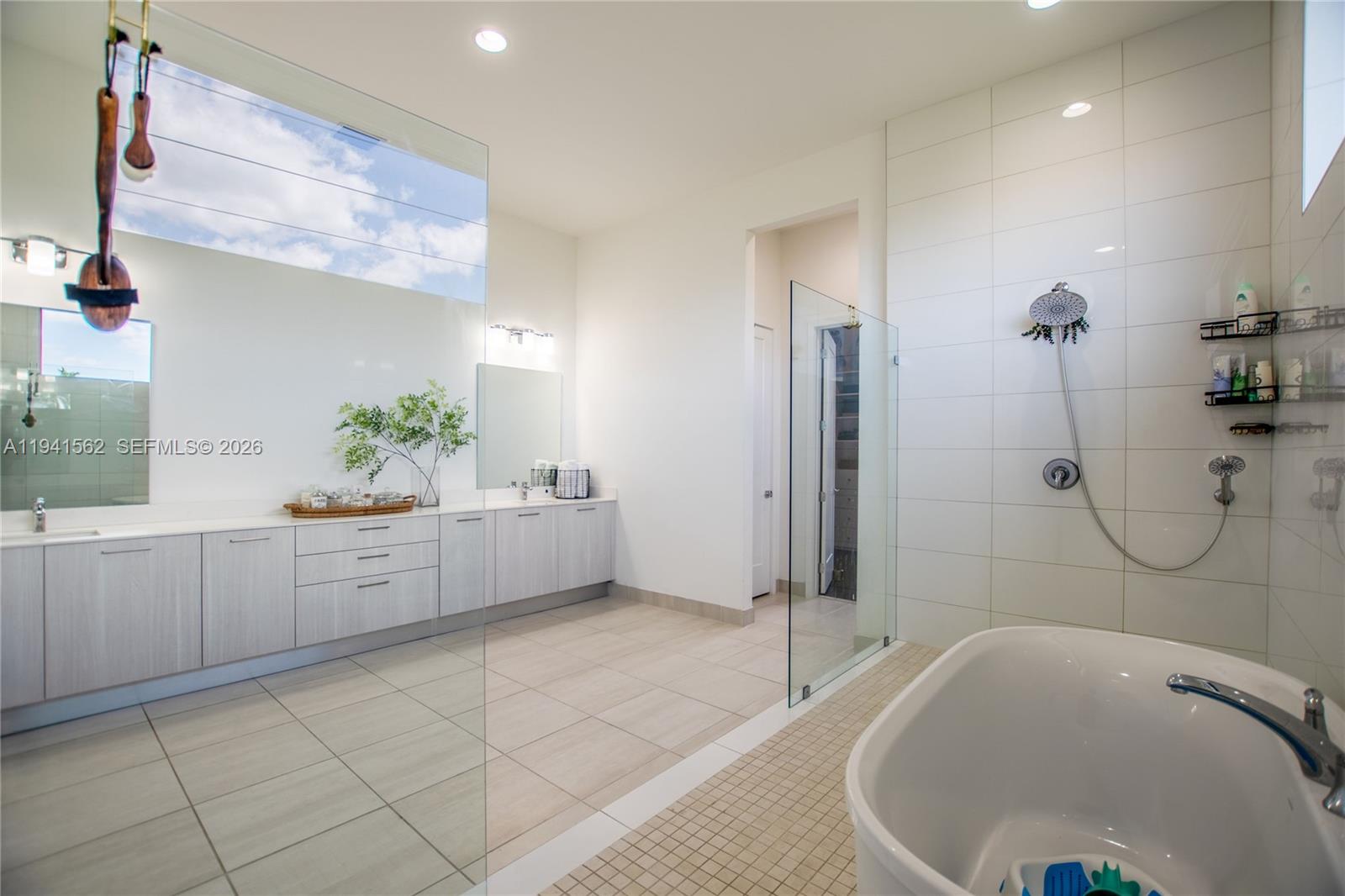 15821 Southwest 49th Street Southwest Ranches, FL 33331 - Photo 33 of 67 a bathroom with a tub sink and mirror
