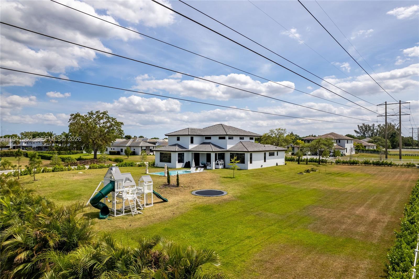 15821 Southwest 49th Street Southwest Ranches, FL 33331 - Photo 4 of 67 a view of a swimming pool and an outdoor seating
