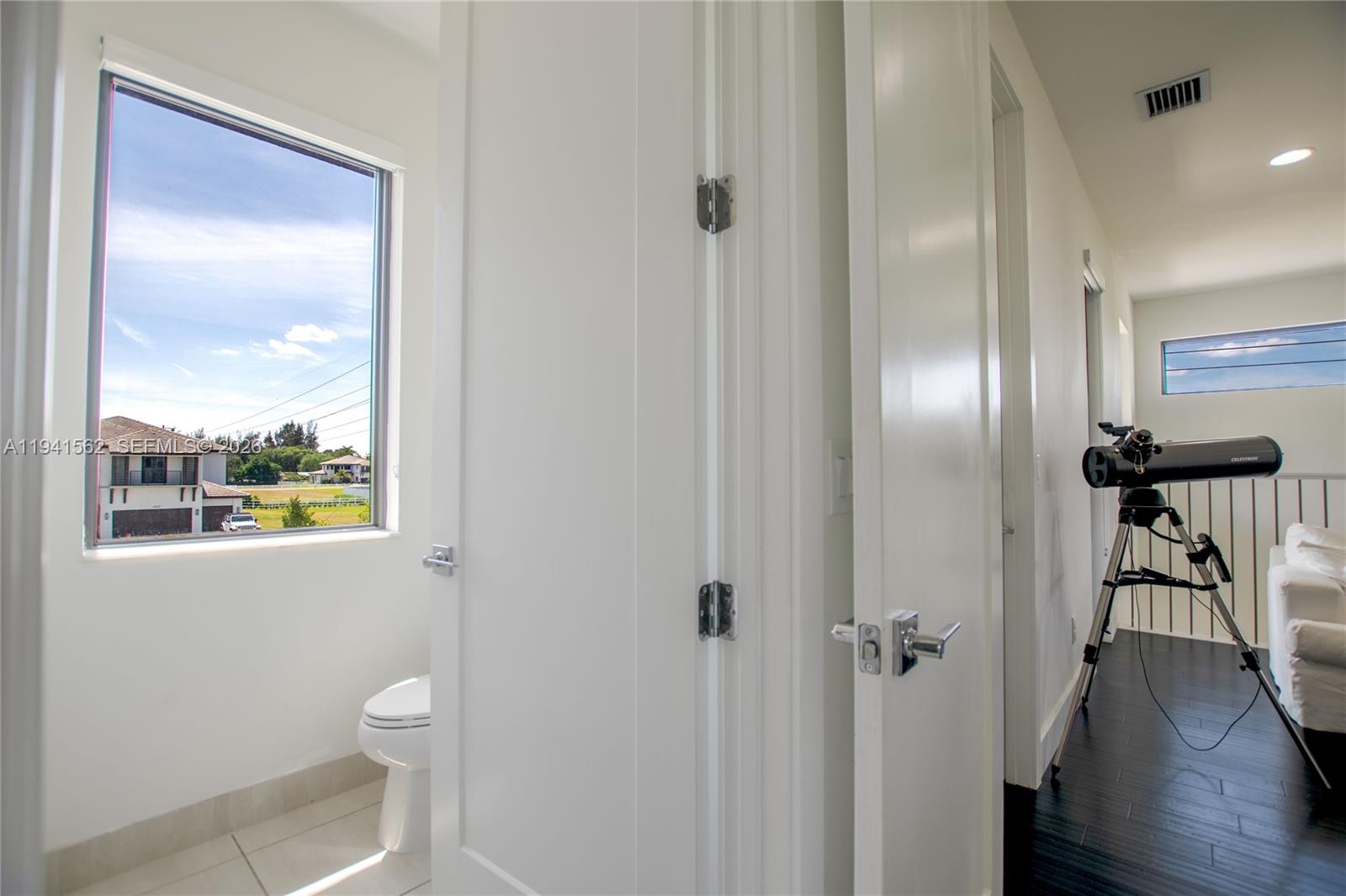 15821 Southwest 49th Street Southwest Ranches, FL 33331 - Photo 44 of 67 a view of a bathroom from the hallway