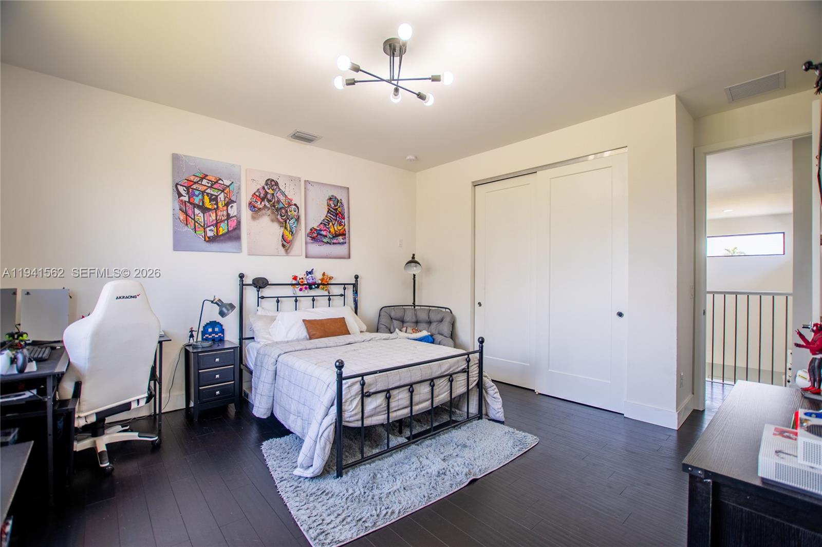 15821 Southwest 49th Street Southwest Ranches, FL 33331 - Photo 50 of 67 a bedroom with a bed and wooden floor