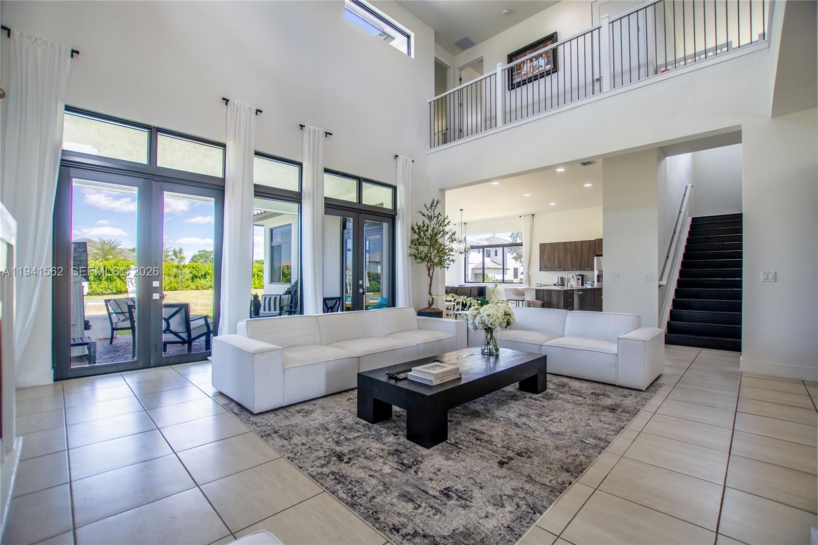 15821 Southwest 49th Street Southwest Ranches, FL 33331 - Photo 7 of 67 a living room with patio furniture and floor to ceiling windows