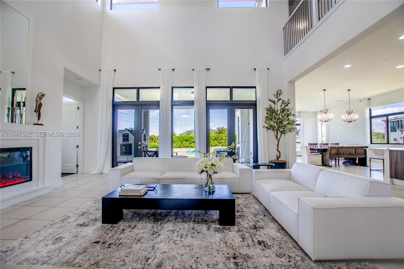 15821 Southwest 49th Street Southwest Ranches, FL 33331 - Photo 9 of 67 a living room with furniture fireplace and large windows