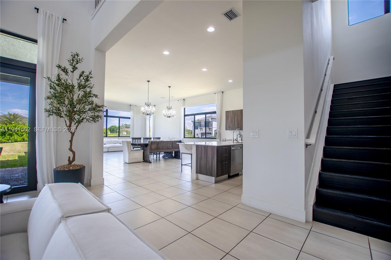 15821 Southwest 49th Street Southwest Ranches, FL 33331 - Photo 10 of 67 a living room with furniture and a potted plant