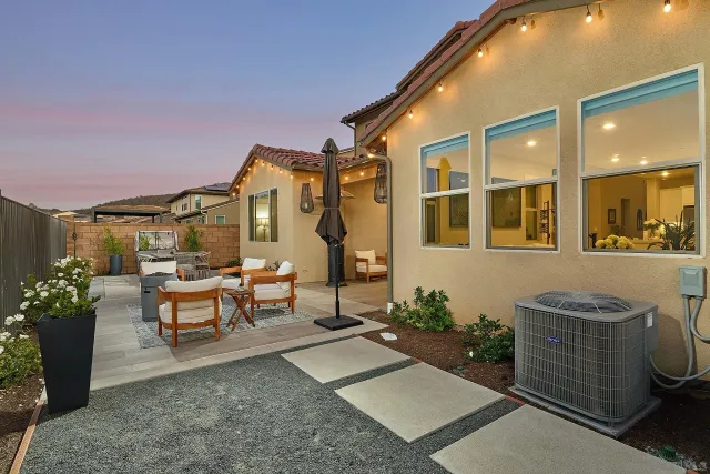a view of a patio with couches table and chairs and potted plants