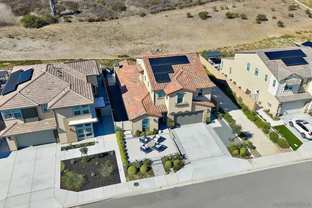 an aerial view of residential houses with outdoor space