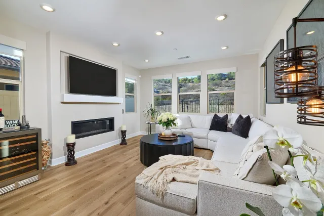 a living room with furniture a fireplace and a flat screen tv
