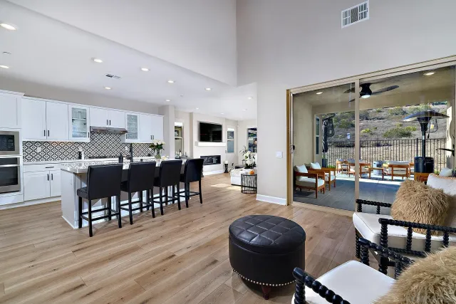 a living room with furniture a dining table and kitchen view