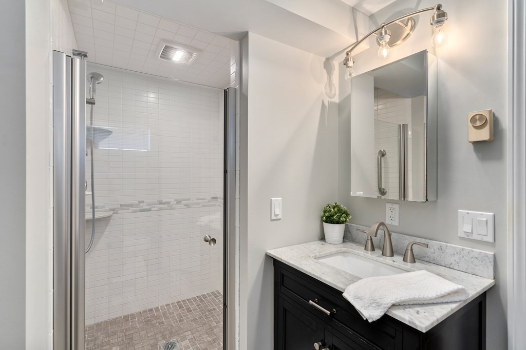 5 Mulberry Lane Canton, MA 02021 - Photo 27 of 36 a bathroom with a granite countertop sink mirror and a shower