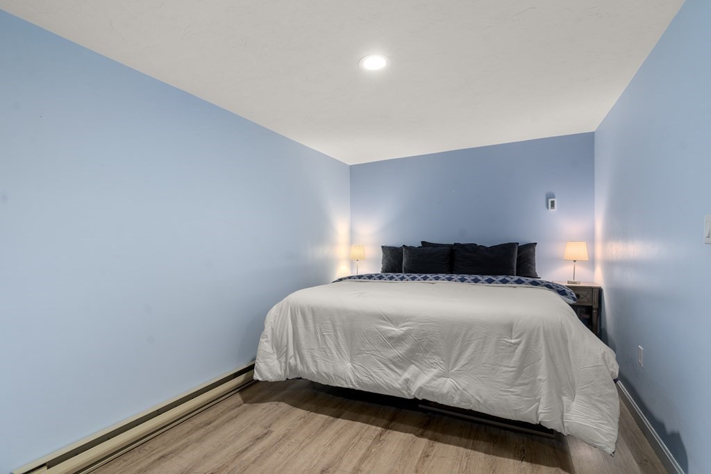 5 Mulberry Lane Canton, MA 02021 - Photo 28 of 36 a bedroom with a bed and wooden floor