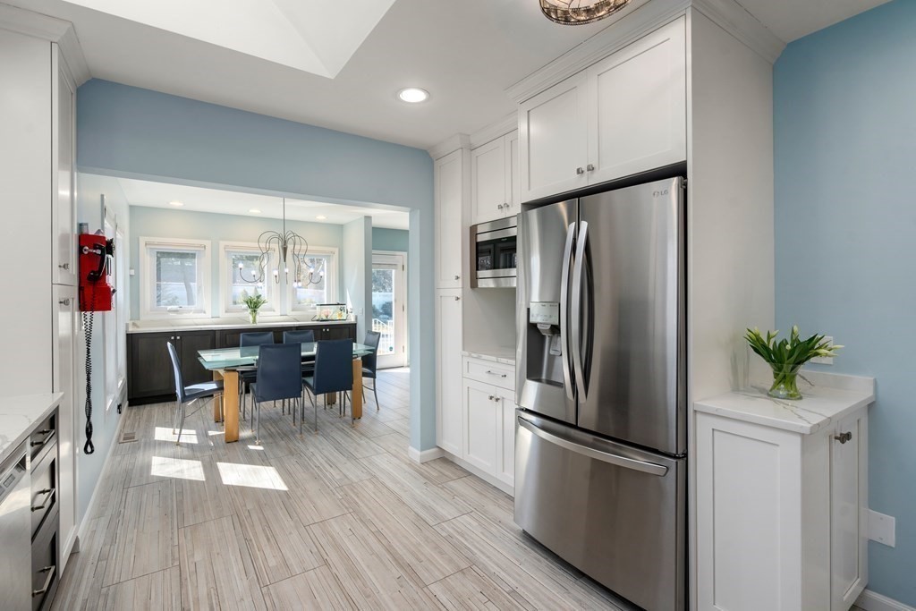5 Mulberry Lane Canton, MA 02021 - Photo 3 of 36 a kitchen with stainless steel appliances a refrigerator and a dining table
