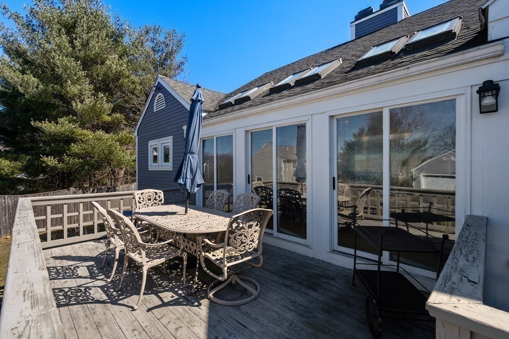5 Mulberry Lane Canton, MA 02021 - Photo 32 of 36 a view of a patio with table and chairs with wooden floor and fence
