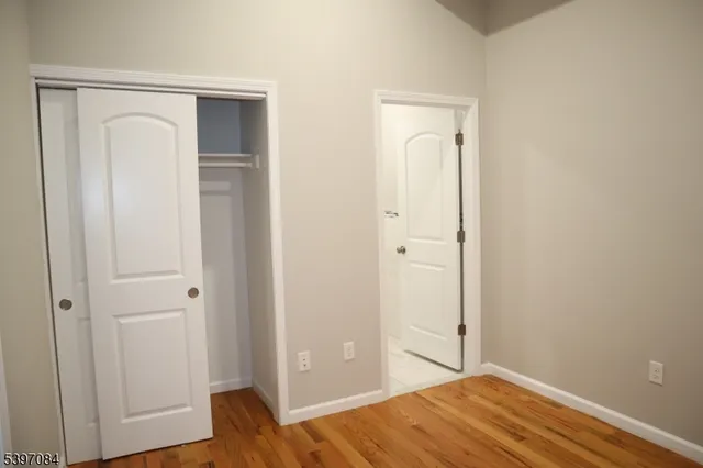 a view of bedroom with wooden floor