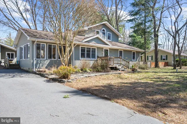 a front view of a house with a yard covered in snow