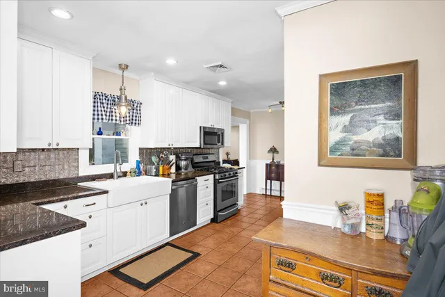 a kitchen with a sink stove and wooden cabinets