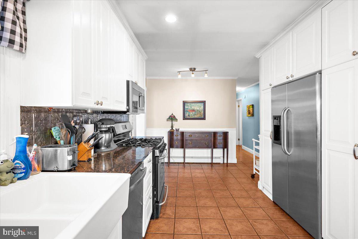 128 Edmore Road Chestertown, MD 21620 - Photo 13 of 59 a kitchen with stainless steel appliances kitchen island granite countertop a refrigerator and a stove