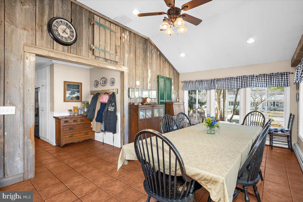 128 Edmore Road Chestertown, MD 21620 - Photo 15 of 59 a dining hall with stainless steel appliances granite countertop a stove a kitchen island with chairs and wooden floor