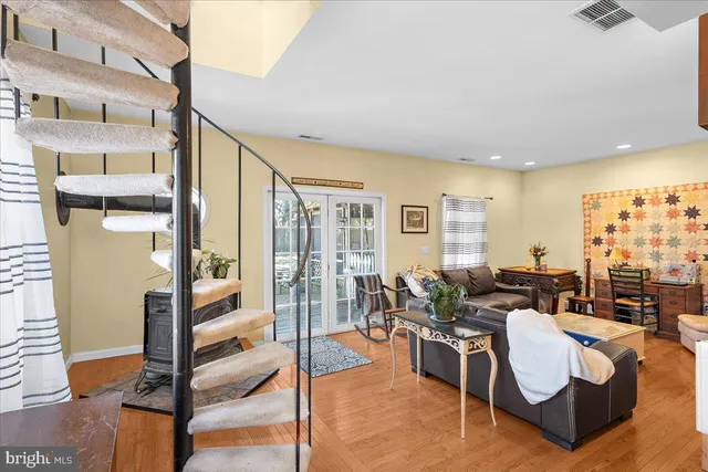 a living room with fireplace furniture and a large window