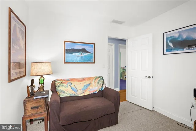 a living room with furniture and a lamp