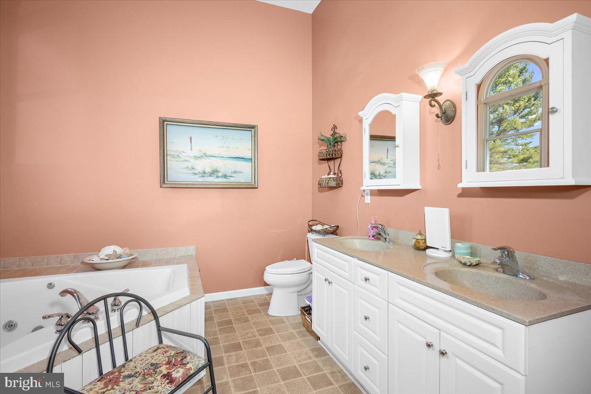128 Edmore Road Chestertown, MD 21620 - Photo 32 of 59 a spacious bathroom with a double vanity sink a toilet and a window