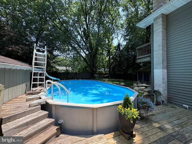 a white house that has a tree in front of it