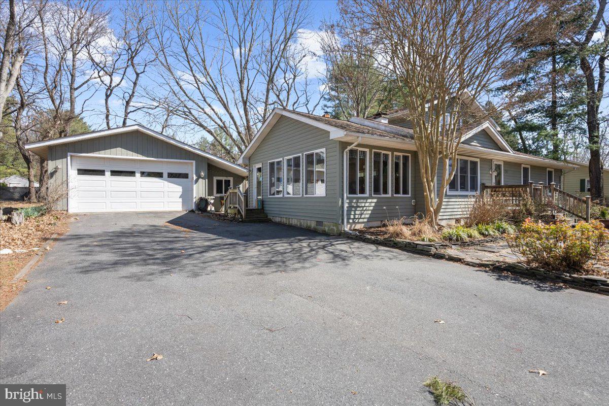 128 Edmore Road Chestertown, MD 21620 - Photo 4 of 59 a front view of a house with a yard and garage