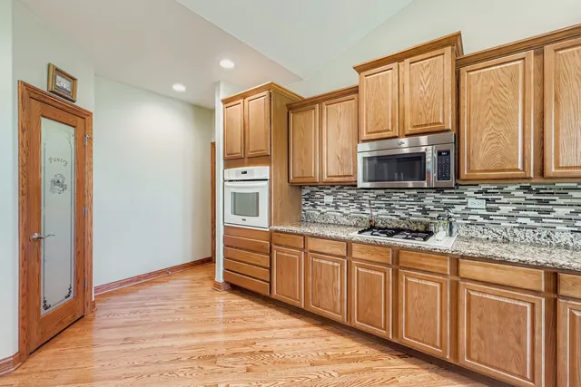 a kitchen with stainless steel appliances granite countertop a refrigerator and a sink