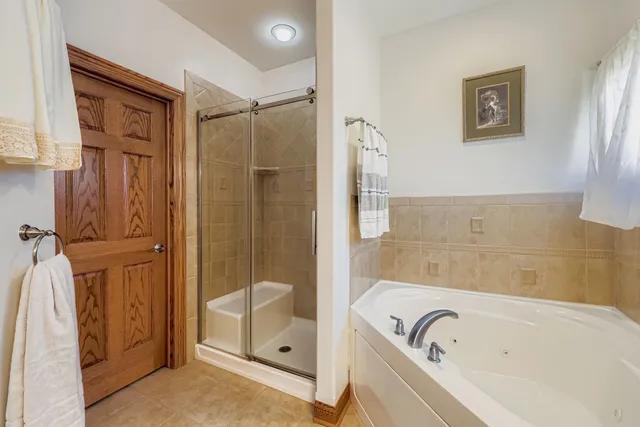 a bathroom with a bathtub and a shower