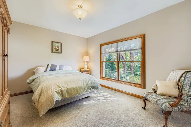 a spacious bedroom with a bed and a large window