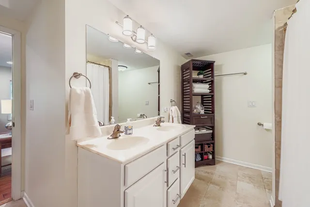 a bathroom with a sink double vanity and a mirror