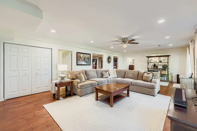 a living room with furniture and a wooden floor