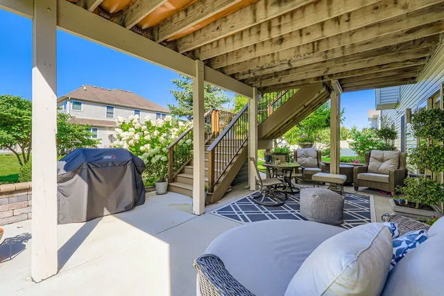 a view of a patio with table and chairs potted plants