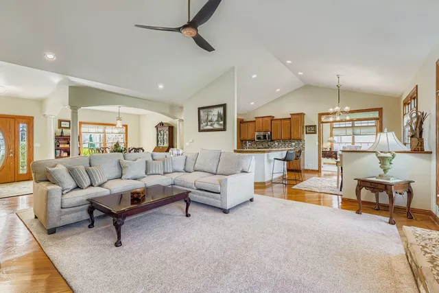 a living room with furniture and a wooden floor