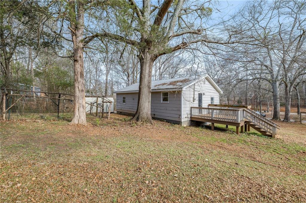 75 Lake Street Jefferson, GA 30549 - Photo 18 of 35 a white house covered with tall trees
