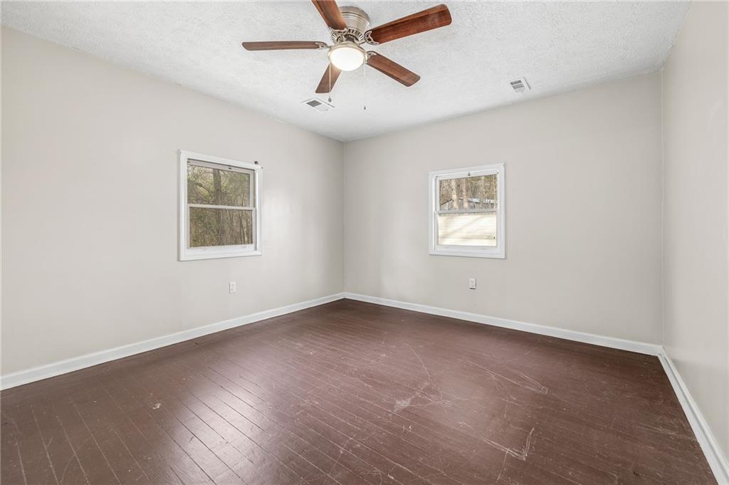75 Lake Street Jefferson, GA 30549 - Photo 10 of 35 an empty room with a window and a ceiling fan