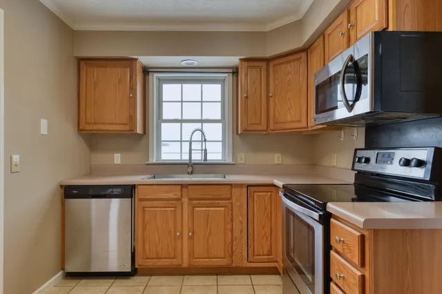 a kitchen with stainless steel appliances granite countertop a sink and a stove