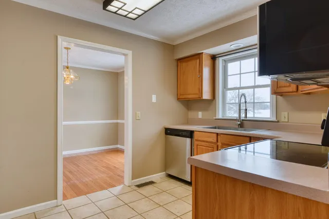 a view of a livingroom with a ceiling fan and wooden floor