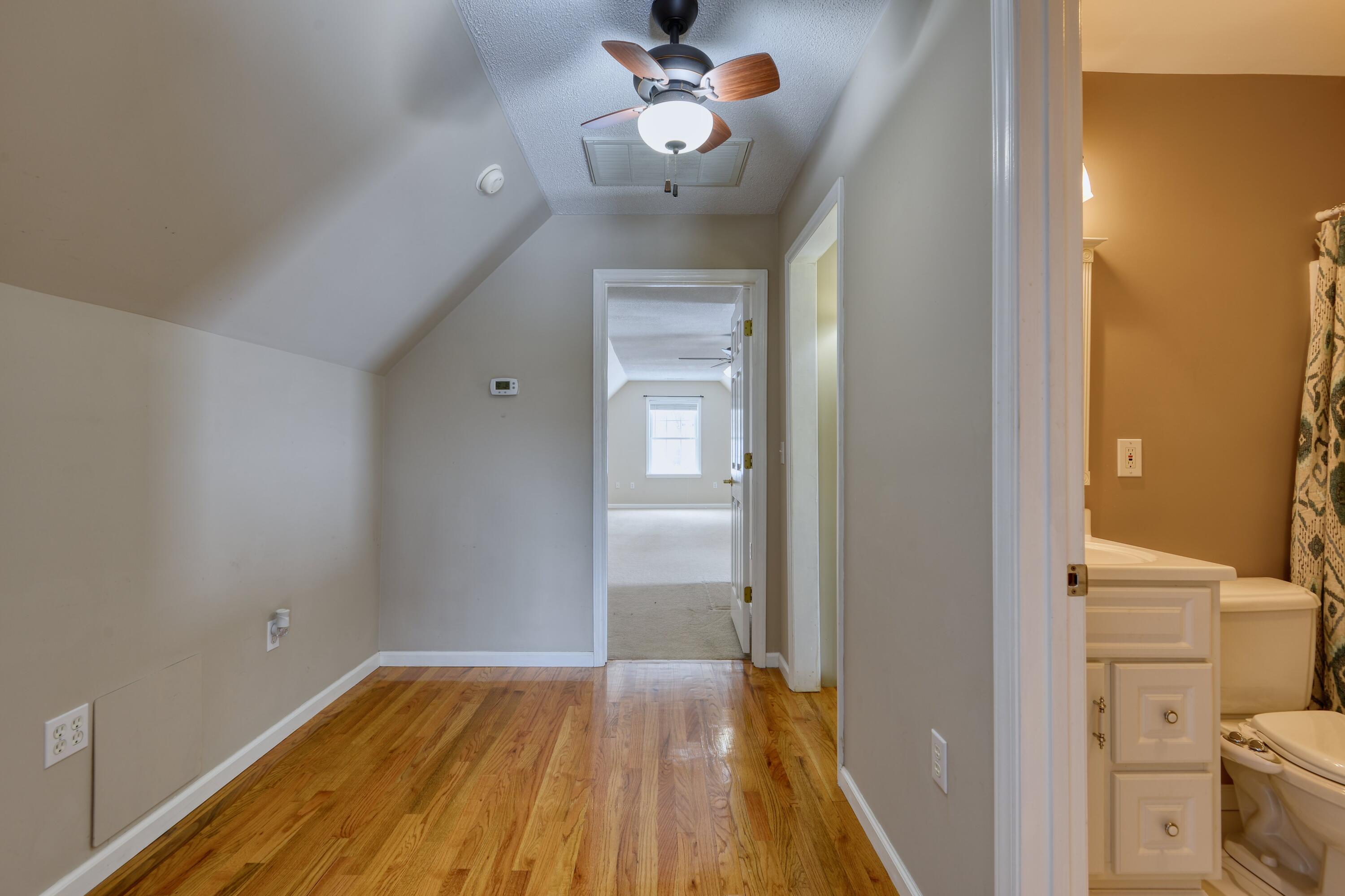 4530 Piney Woods Road Riner, VA 24149 - Photo 27 of 60 a view of a hallway with wooden floor and a bathroom