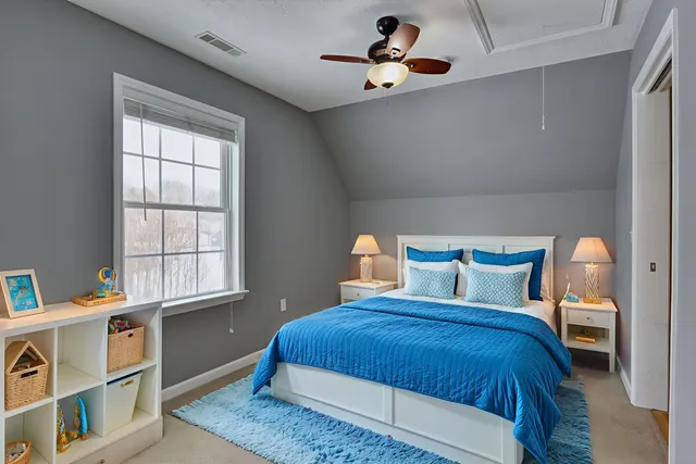 a bedroom with a bed a ceiling fan and a dresser