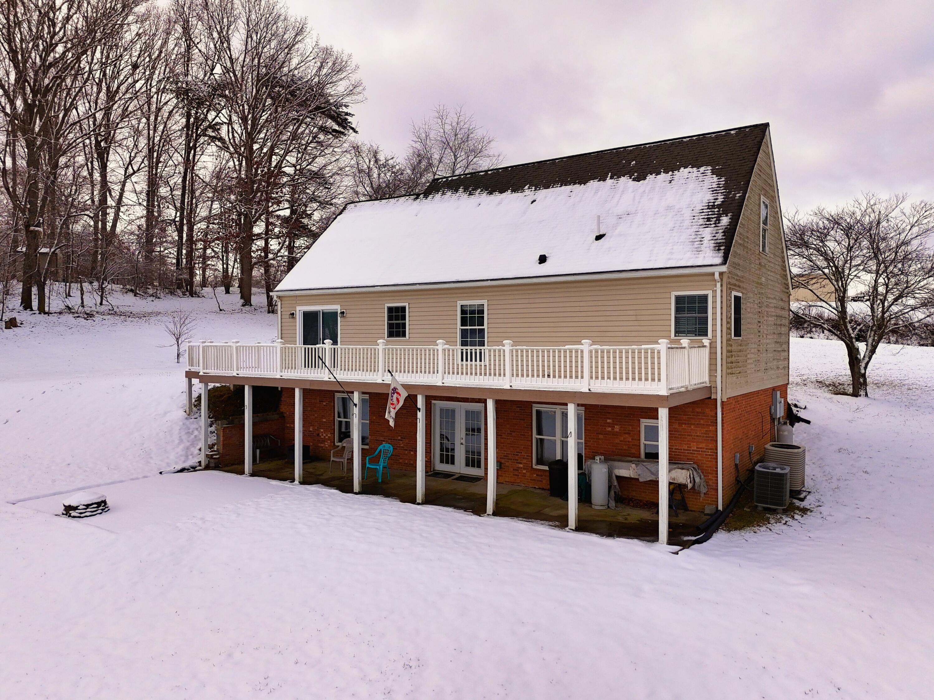 4530 Piney Woods Road Riner, VA 24149 - Photo 56 of 60 a view of a house with a yard covered in snow
