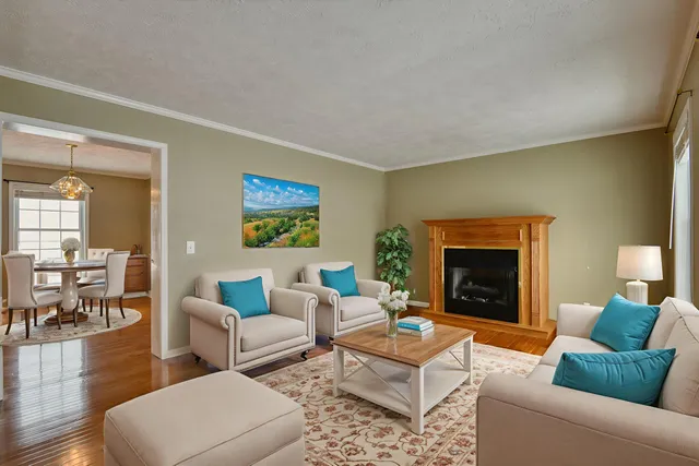 a view of an empty room with wooden floor and stairs