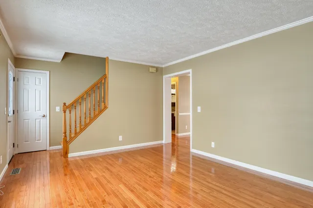 wooden floor fireplace and windows in an empty room