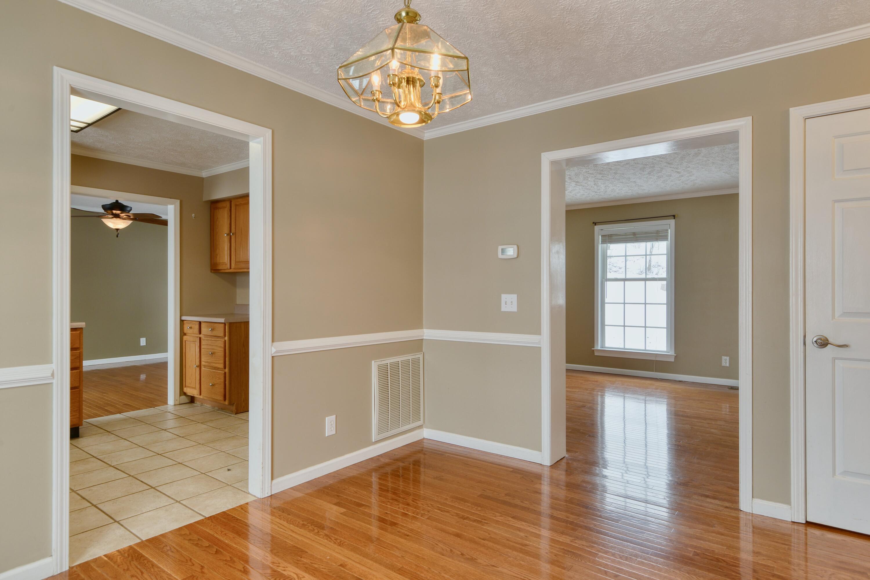 4530 Piney Woods Road Riner, VA 24149 - Photo 10 of 60 wooden floor in an empty room with a window