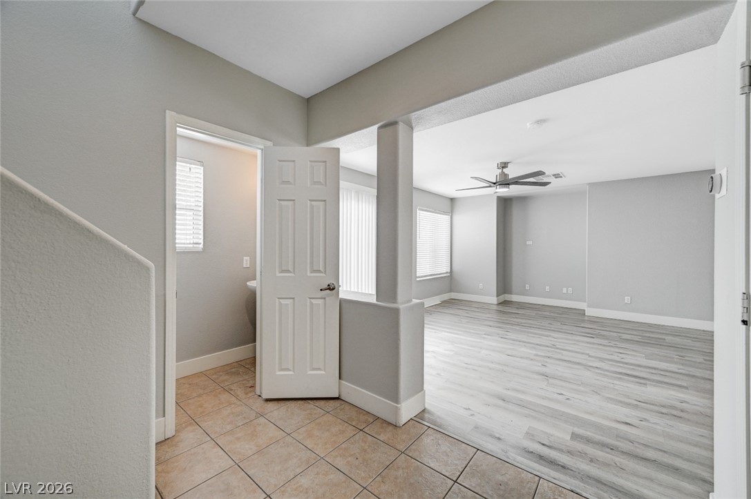 7259 Cestrum Road Las Vegas, NV 89113 - Photo 4 of 35 A versatile open-concept living space features light-toned flooring and abundant natural illumination.
