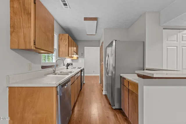 a kitchen with a sink stove and refrigerator