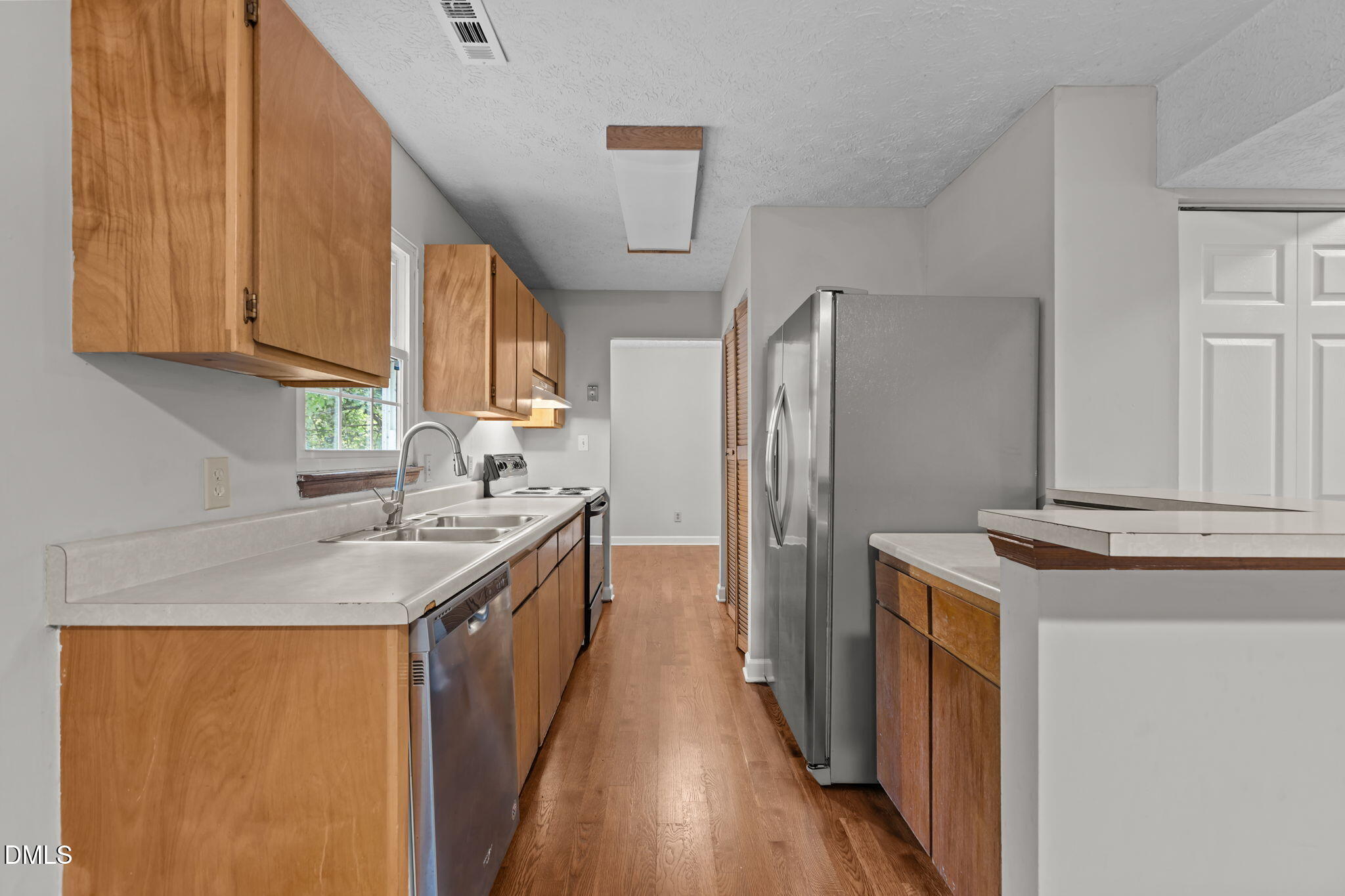 2501 Anne Carol Court Raleigh, NC 27603 - Photo 11 of 36 a kitchen with a sink stove and refrigerator