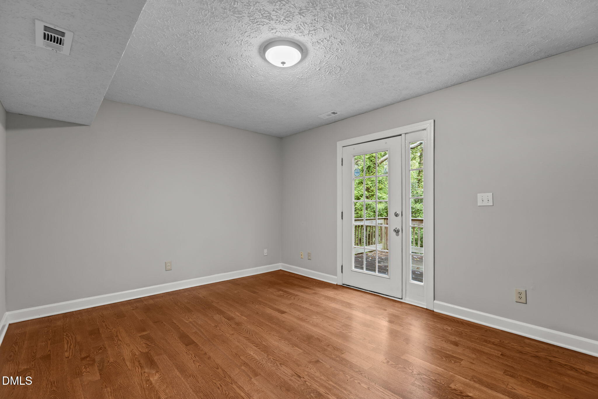 2501 Anne Carol Court Raleigh, NC 27603 - Photo 14 of 36 a view of an empty room with wooden floor and a window