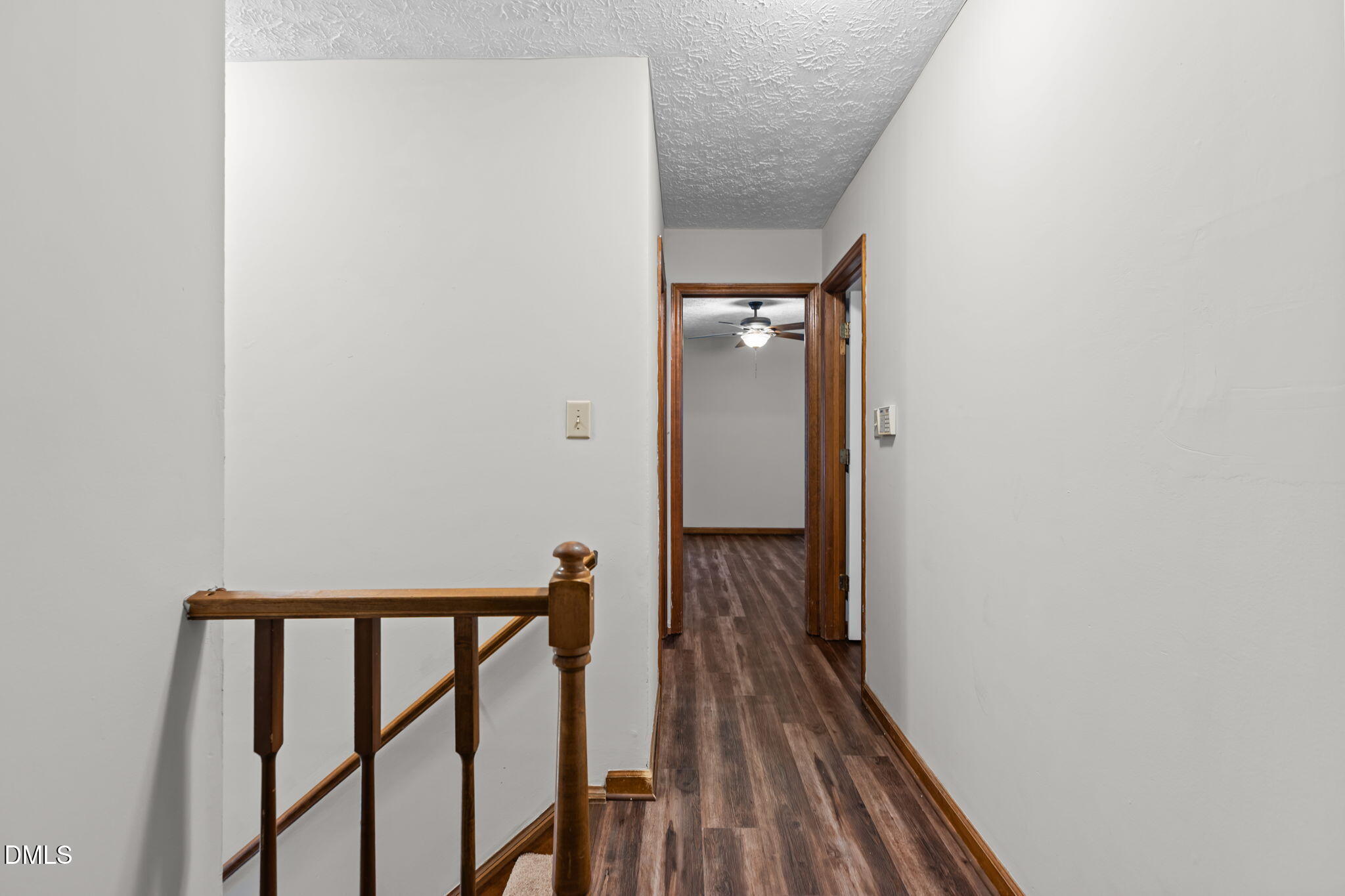 2501 Anne Carol Court Raleigh, NC 27603 - Photo 17 of 36 a view of a hallway with wooden floor and staircase